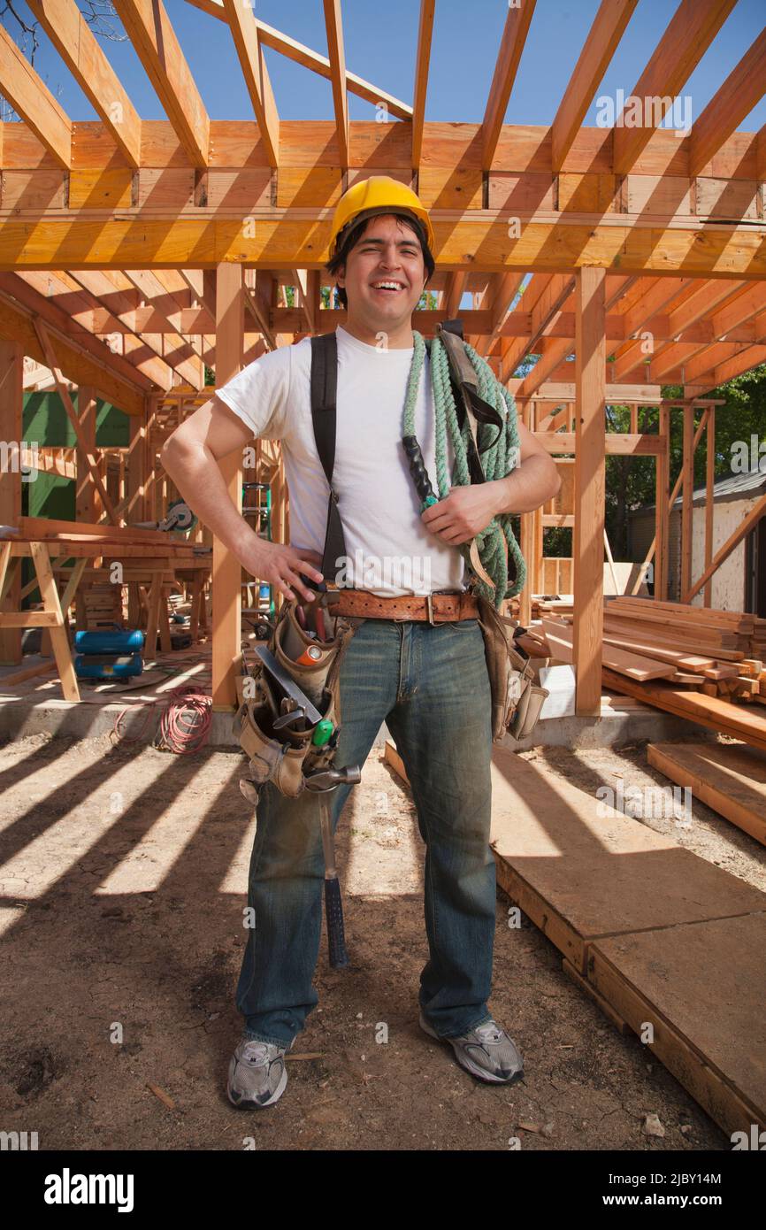 Portrait of a construction worker wearing a hard hat and a tool belt