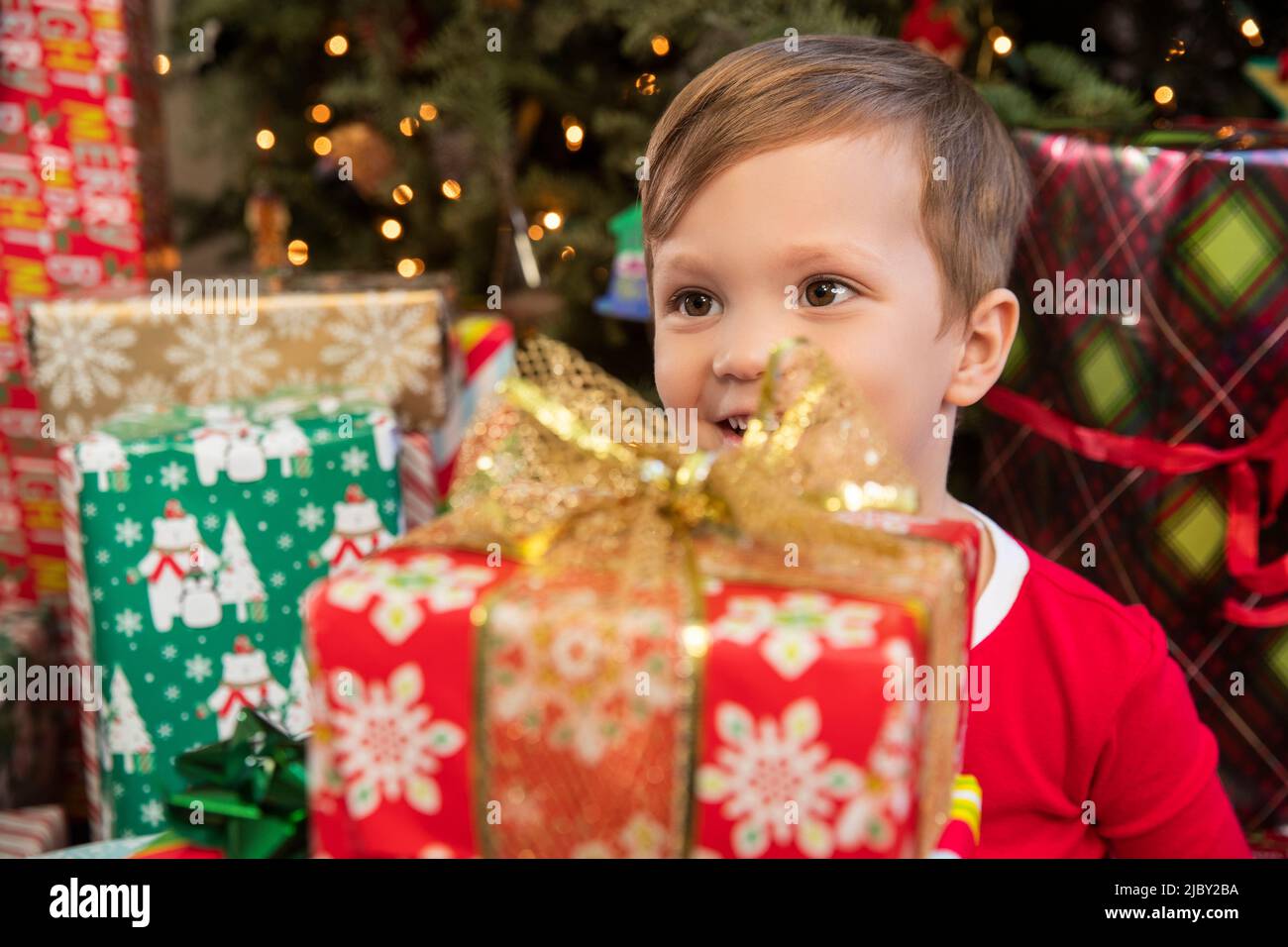 Young excited boy opening presents on Christmas morning Stock Photo