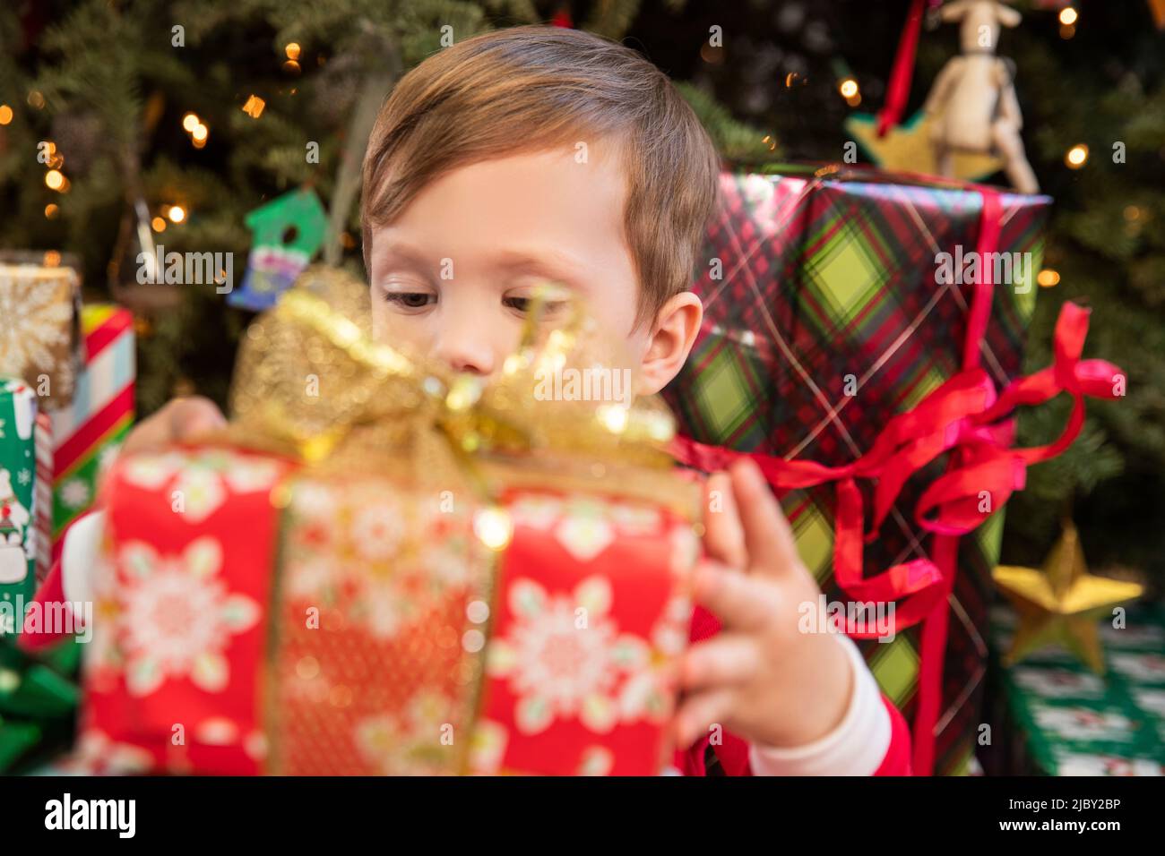 Excited boy opening gifts on Christmas Stock Photo