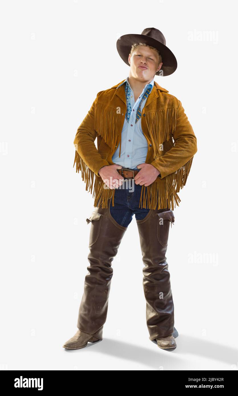 Portrait of Caucasian man dressed in a cowboy costume for Halloween smiling and making at face at camera, against a white background Stock Photo