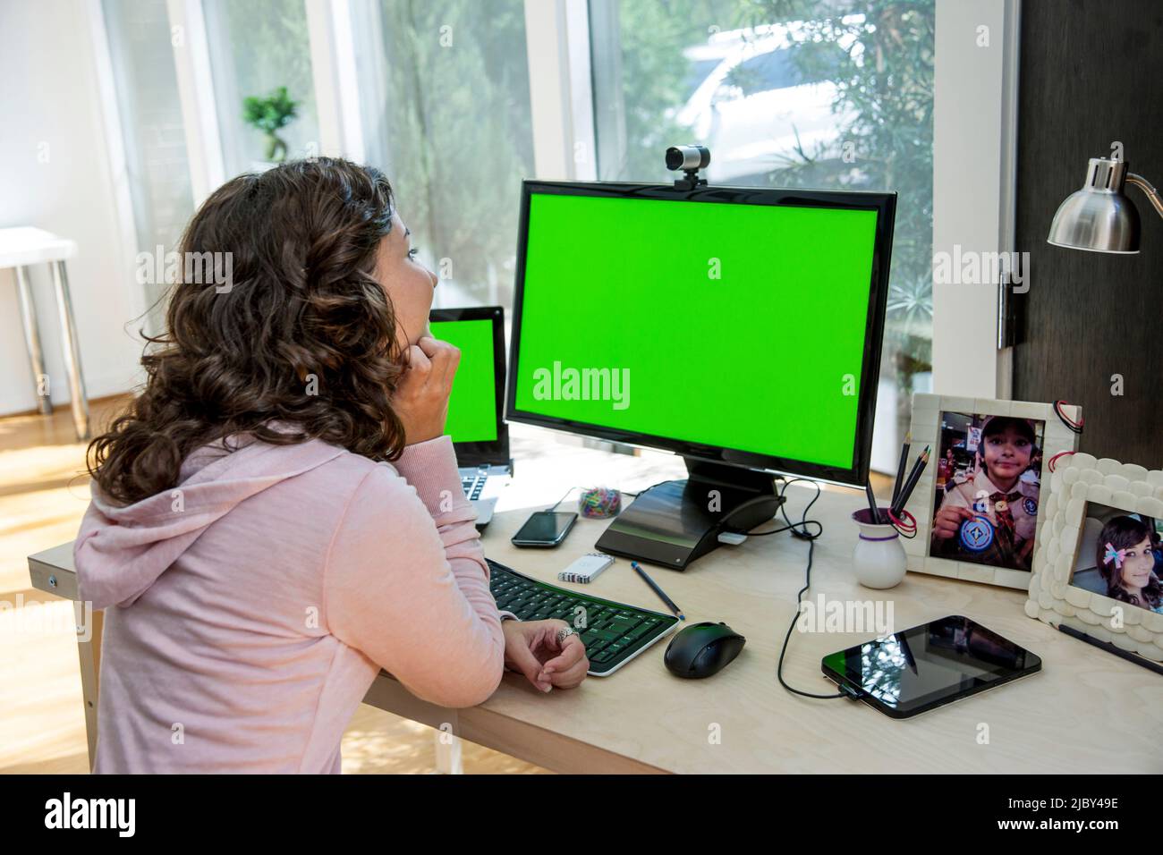 Young Hispanic woman on a video call in home office Stock Photo