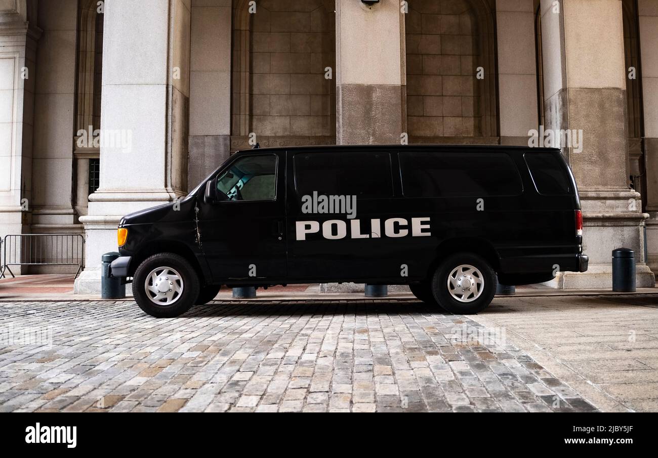 A black police van parked near New York City Hall and the Tweed Courthouse and Comptroller in Manhattan. Stock Photo