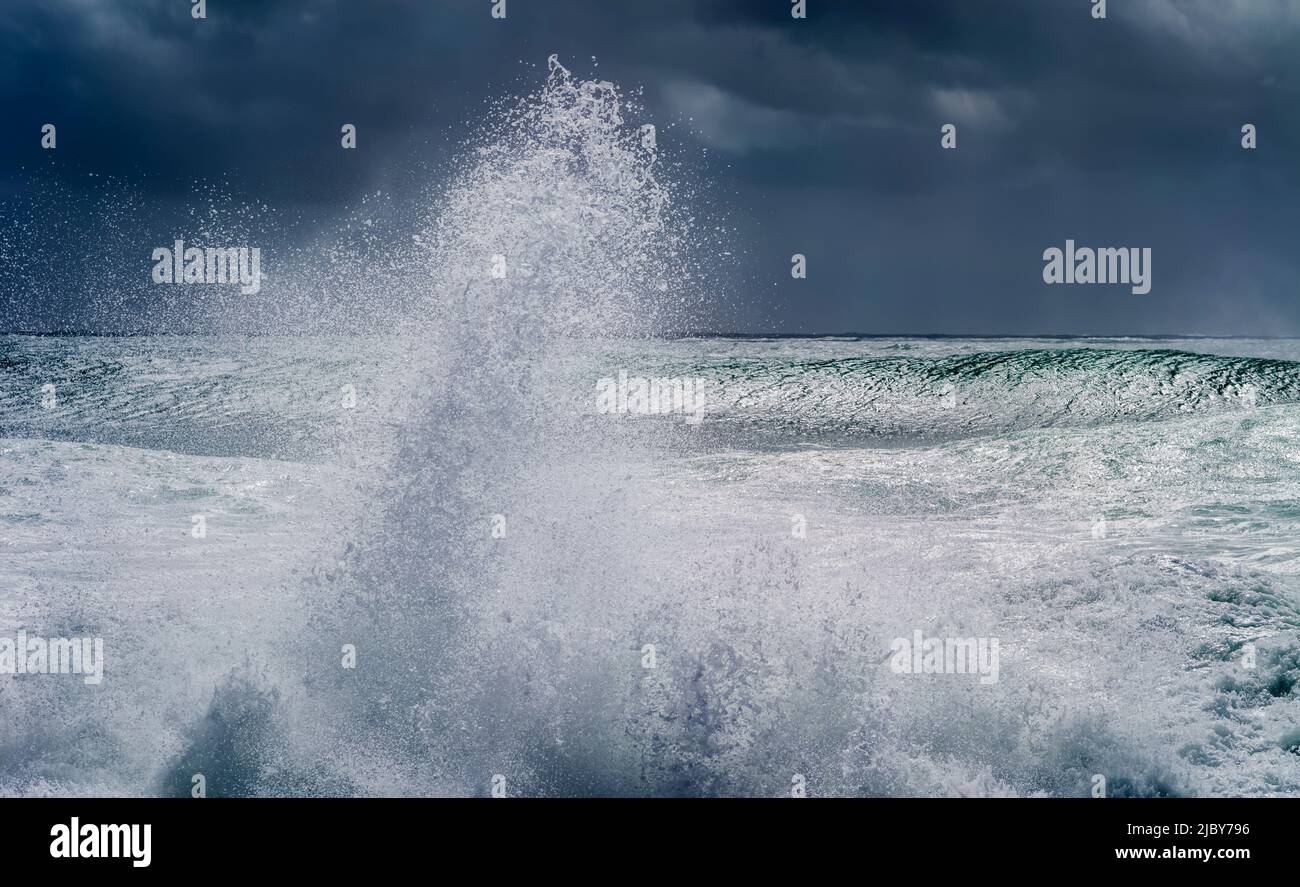 Wave curling over and breaking during cyclone Ola with stormy sky Stock Photo