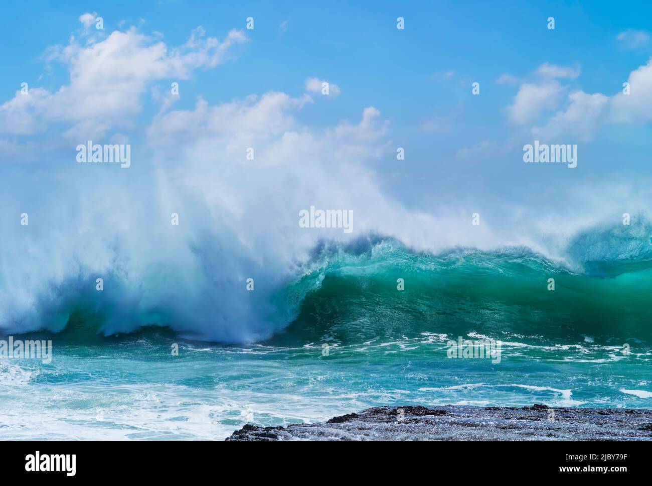 Huge wave curling over and breaking during cyclone Ola Stock Photo