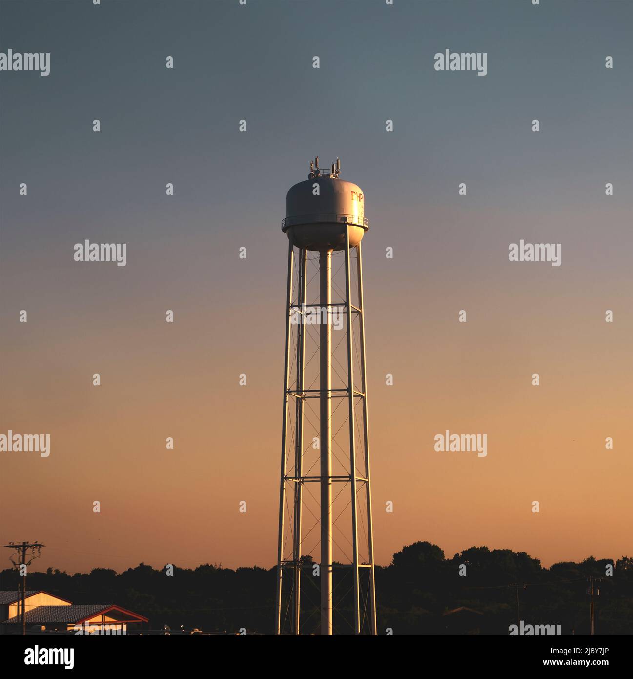 A water tower in East Texas at sunset Stock Photo