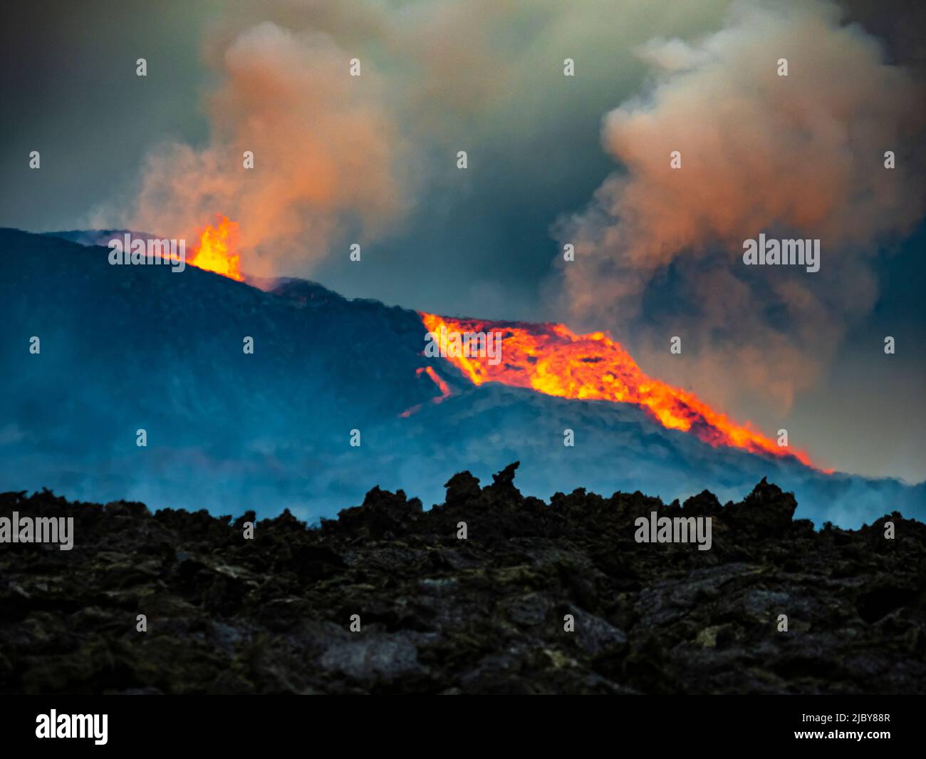 Glowing lava is ejected skyward as lava spills from Fagradalsfjall