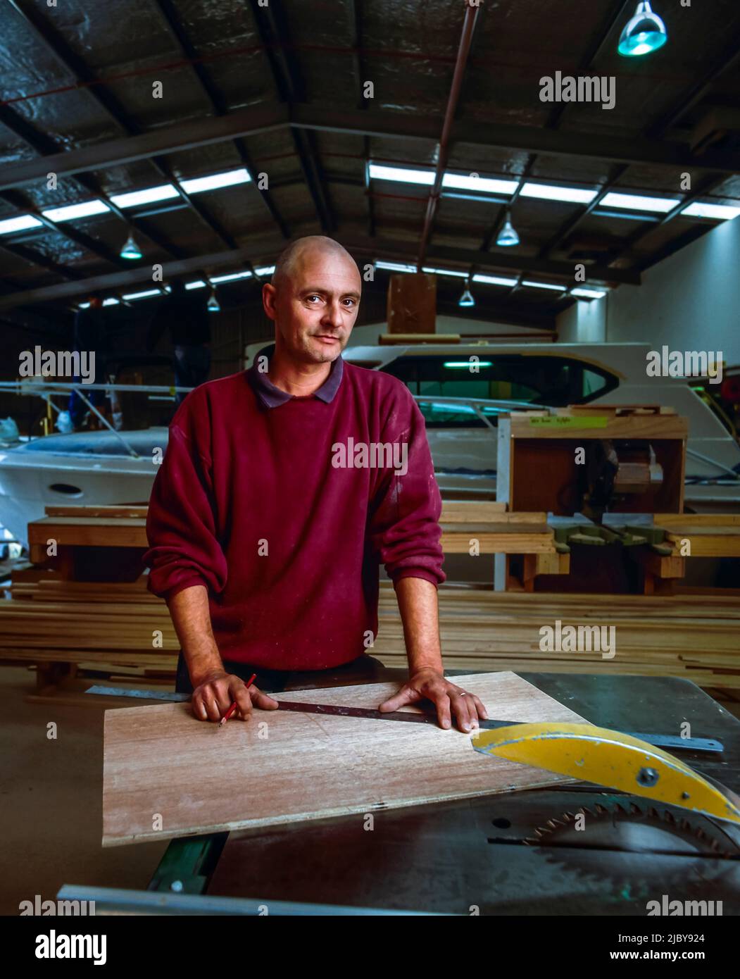 Portrait of a boat builder in his factory Stock Photo