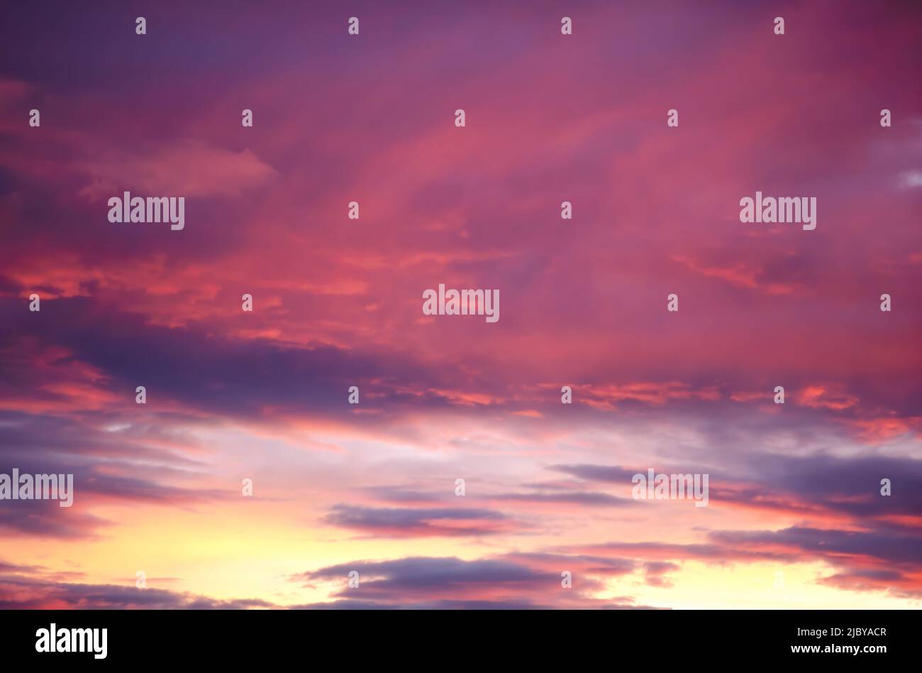 Pink clouds in purple sky at sunset Stock Photo - Alamy