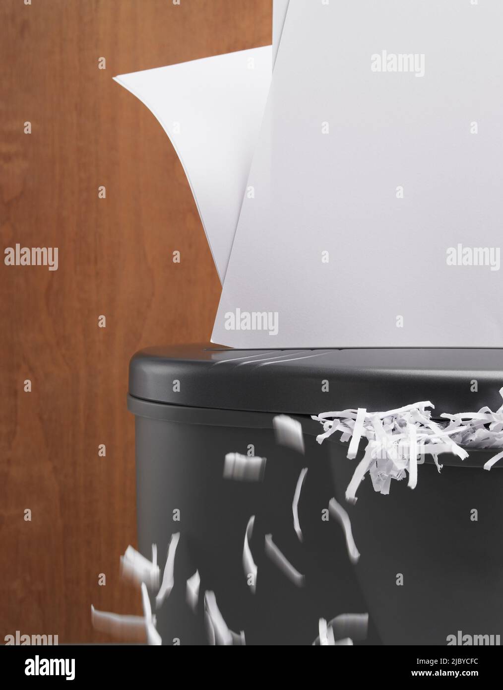 Documents being shredded and shredded paper spilling out Stock Photo Alamy