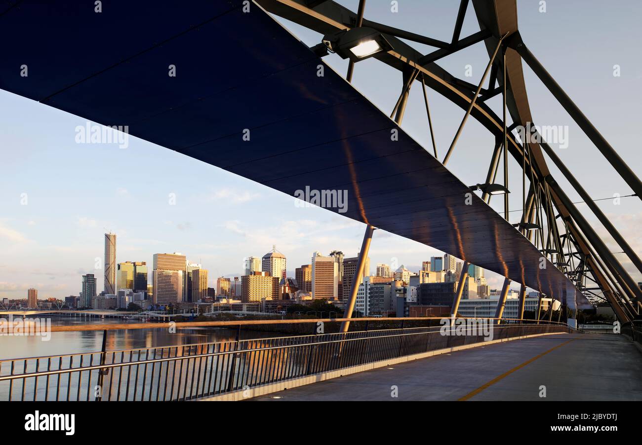 Modern Pedestrian Bridge spanning over Brisbane River linking city to Southbank in early morning light Stock Photo