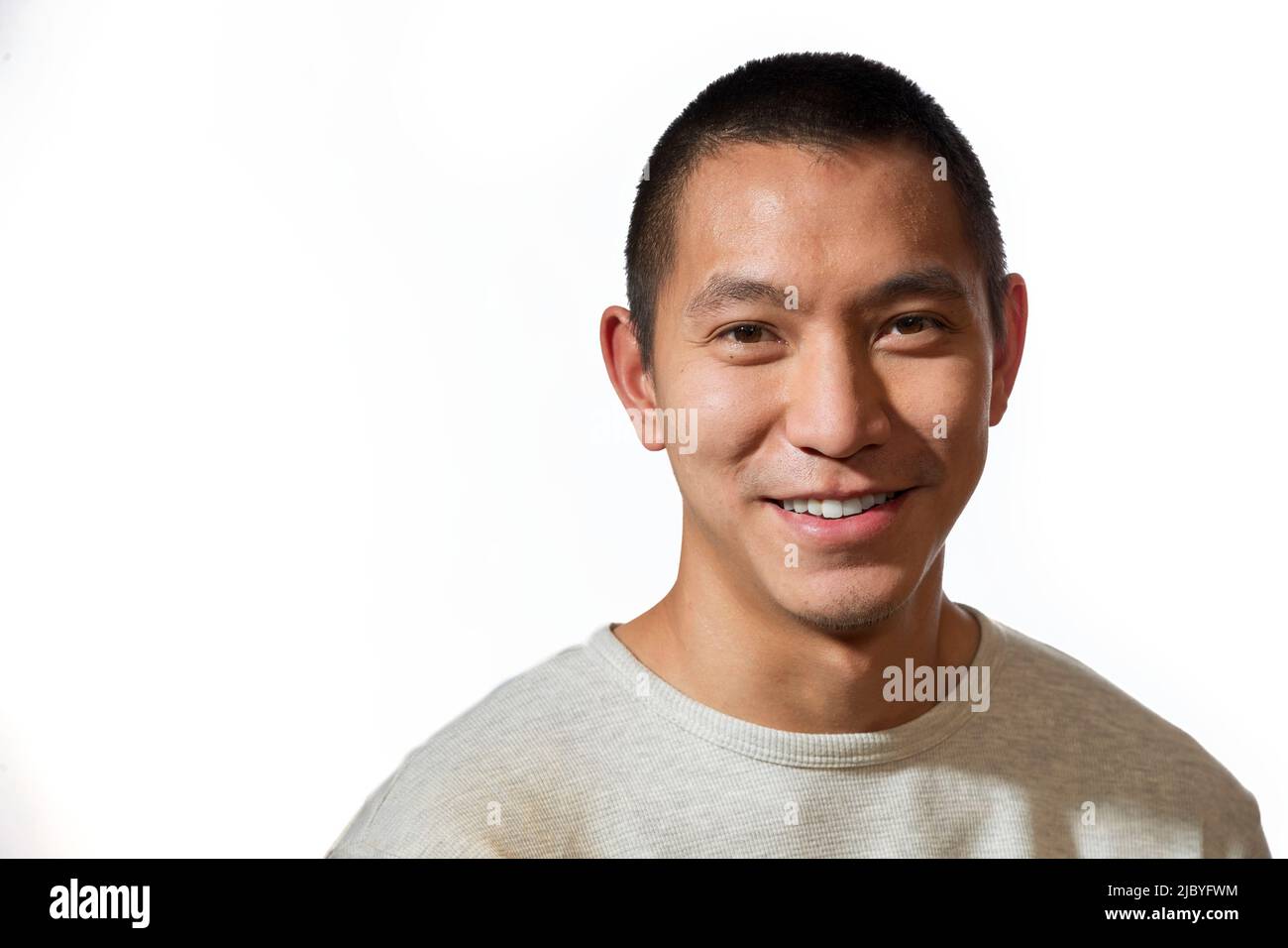 Portrait of young man of Asian descent looking at camera with smile Stock Photo