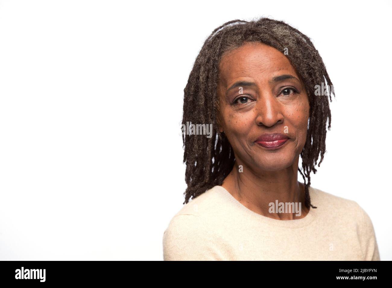 Subdue Images Portrait of older black woman looking at camera with subdued smile ...