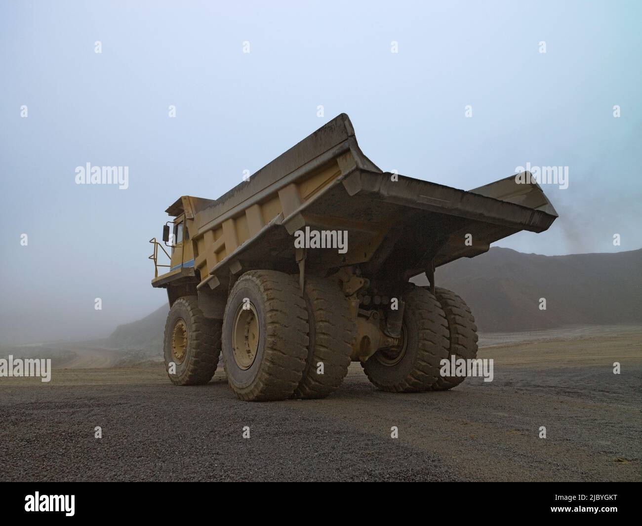 Empty earth moving truck in misty quarry Stock Photo