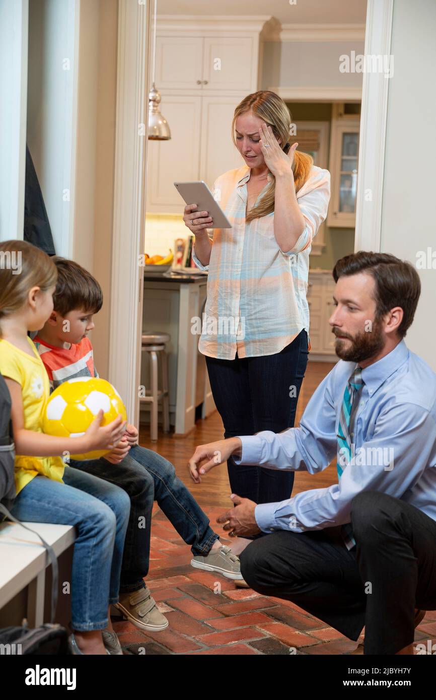 ly in the morning getting, dad getting kids shoes on in mudroom before ...