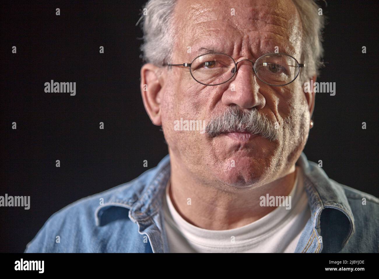 Serious older man wearing eyeglasses Stock Photo