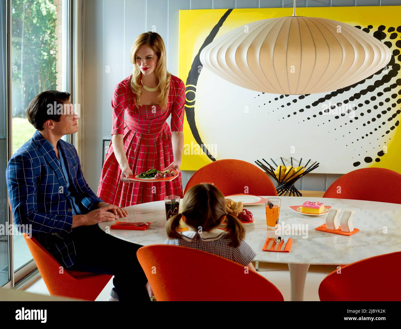 Contemporary family at the dining table in a mid-century modern home Stock Photo