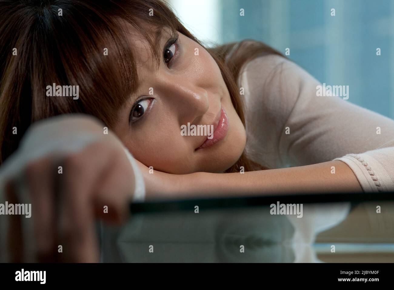 Woman leaning on table Stock Photo