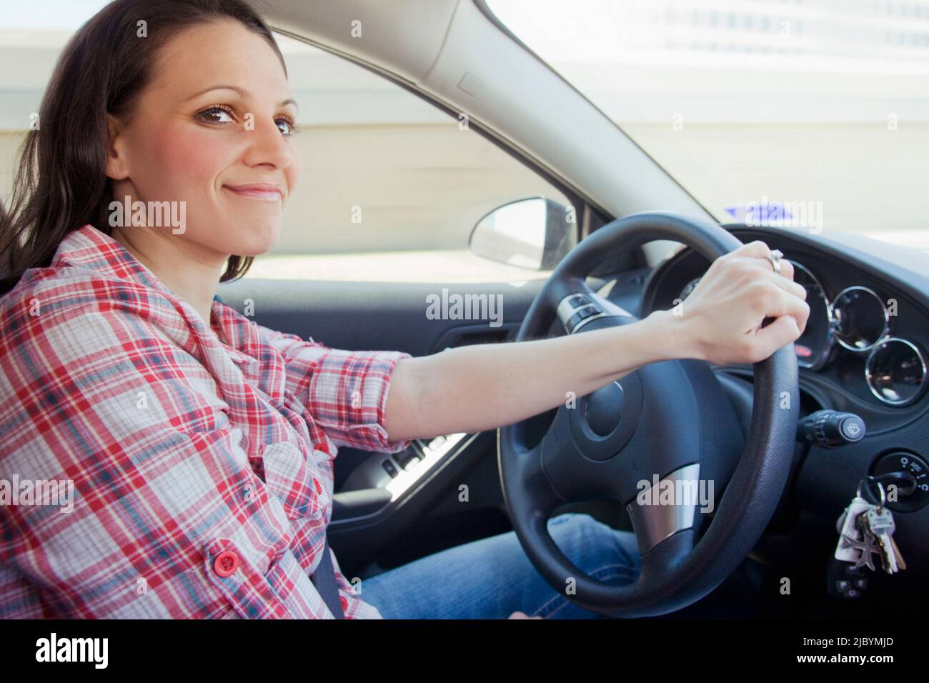 Smiling woman driving car Stock Photo