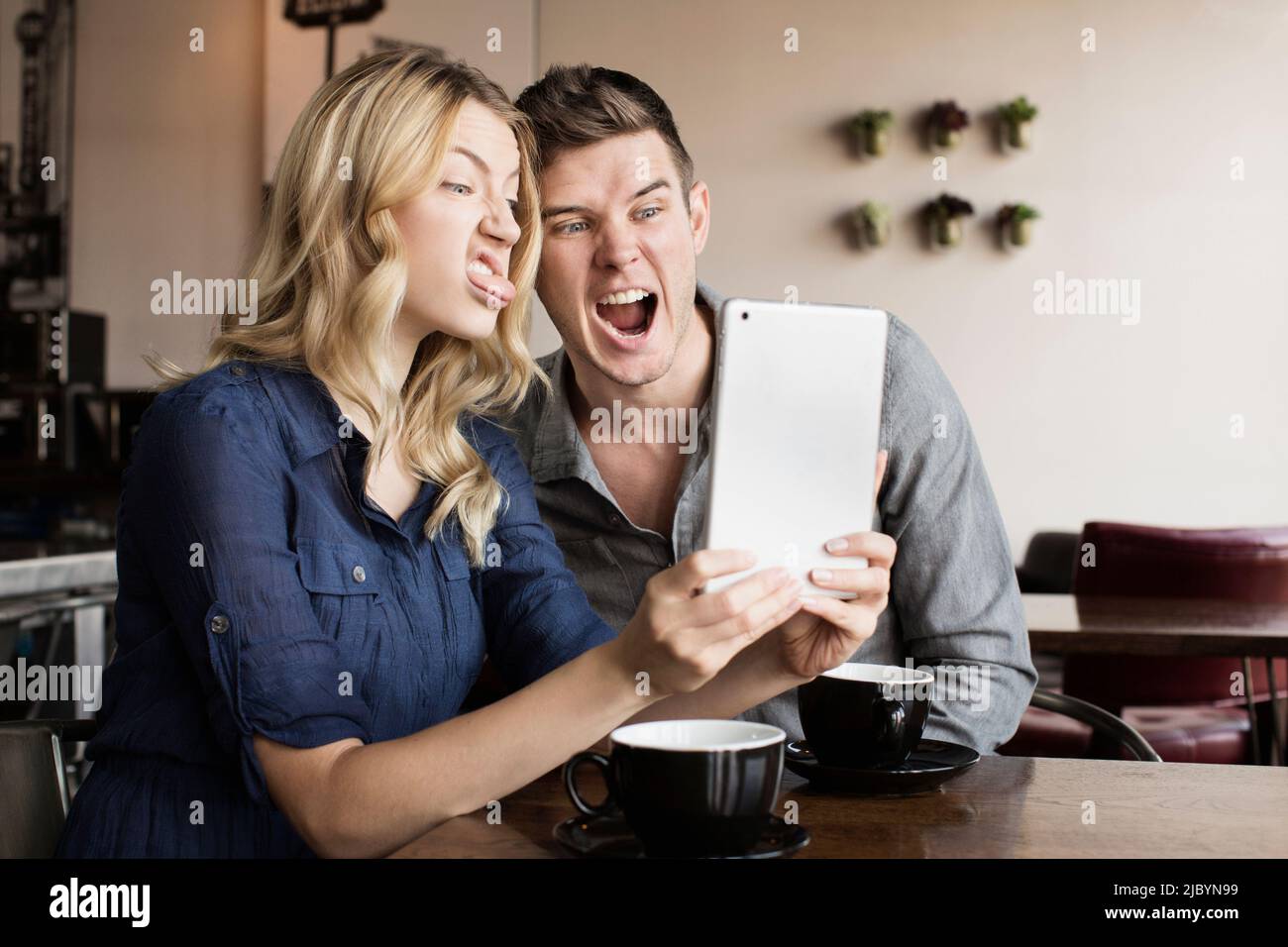 Caucasian couple using digital tablet together Stock Photo