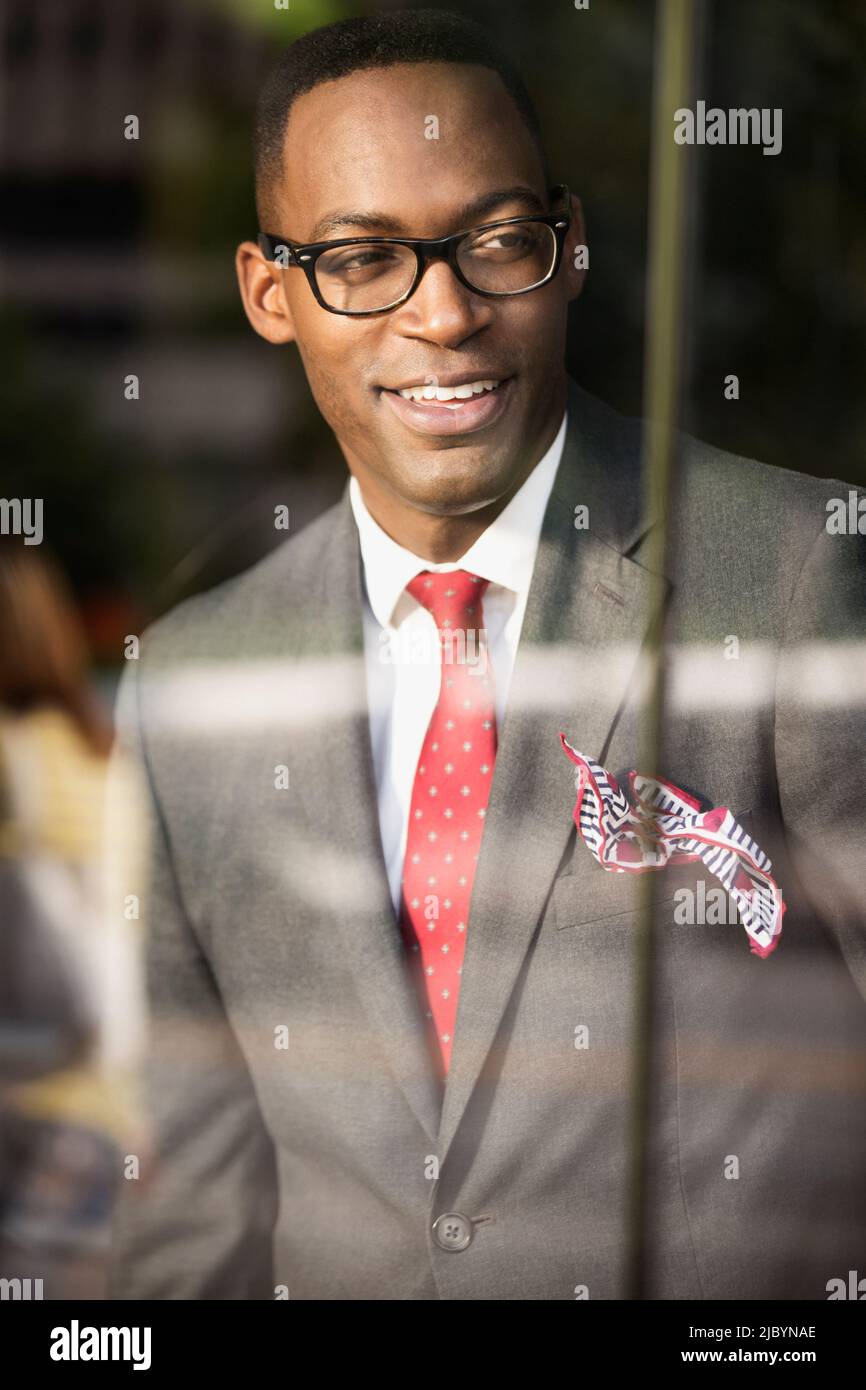 Black businessman looking out office window Stock Photo