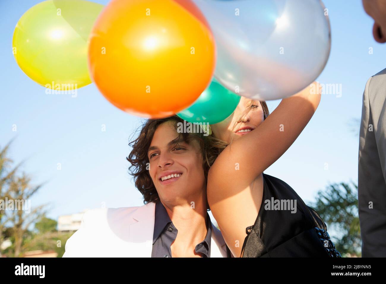 Couple holding balloons at party Stock Photo