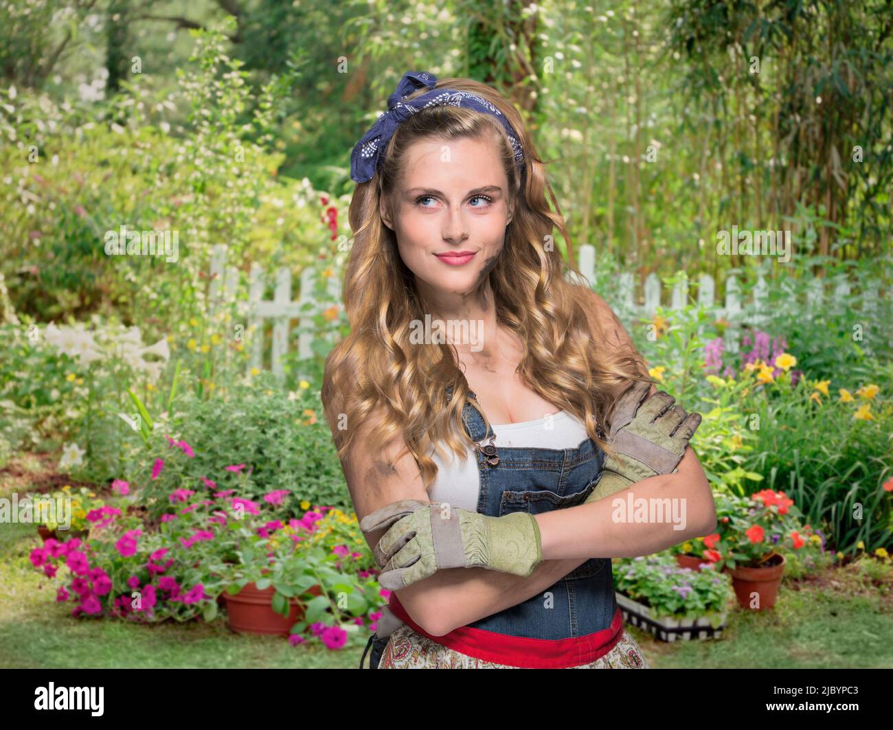 Woman wearing gardening gloves in garden Stock Photo