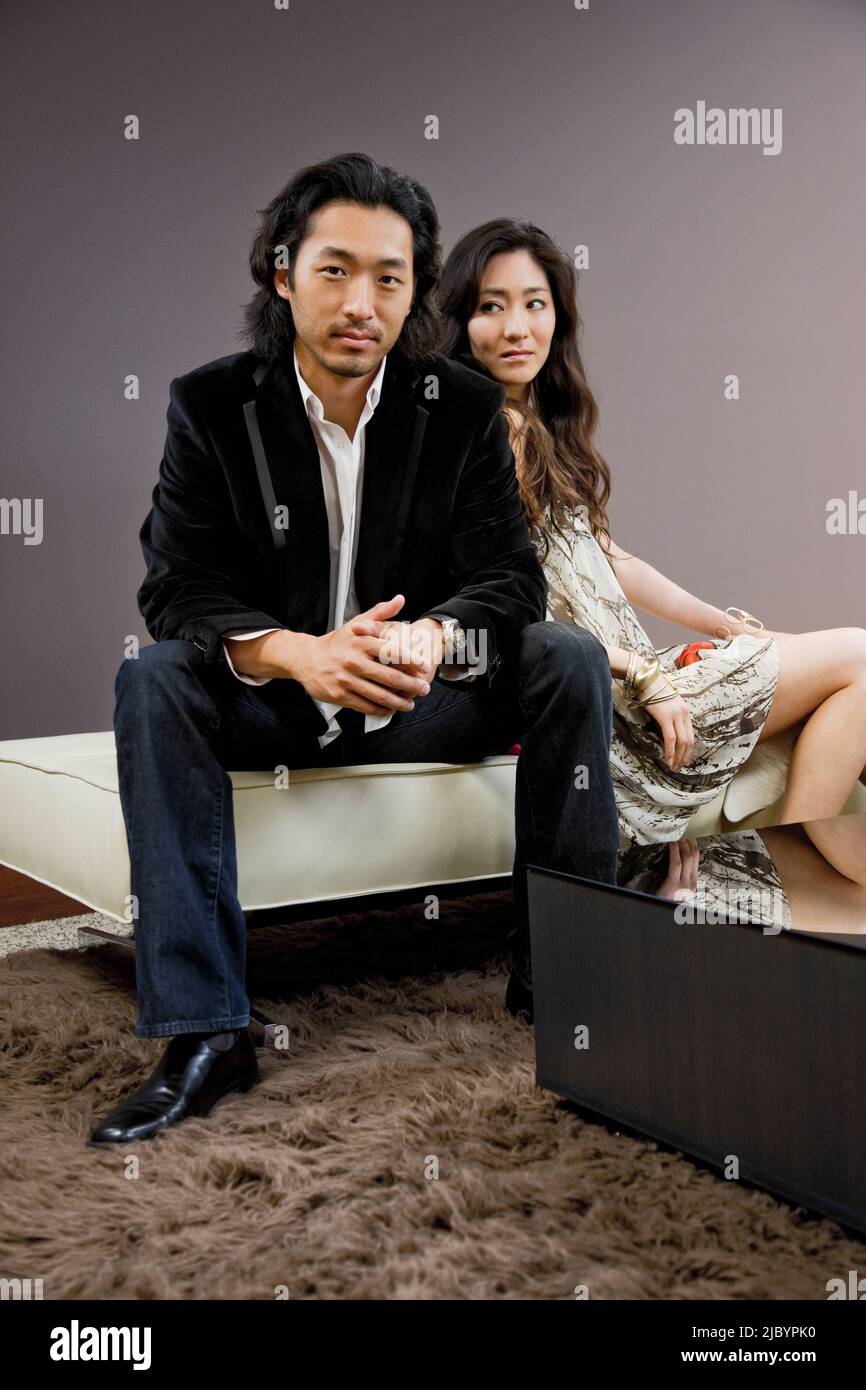 Korean couple sitting on stool Stock Photo
