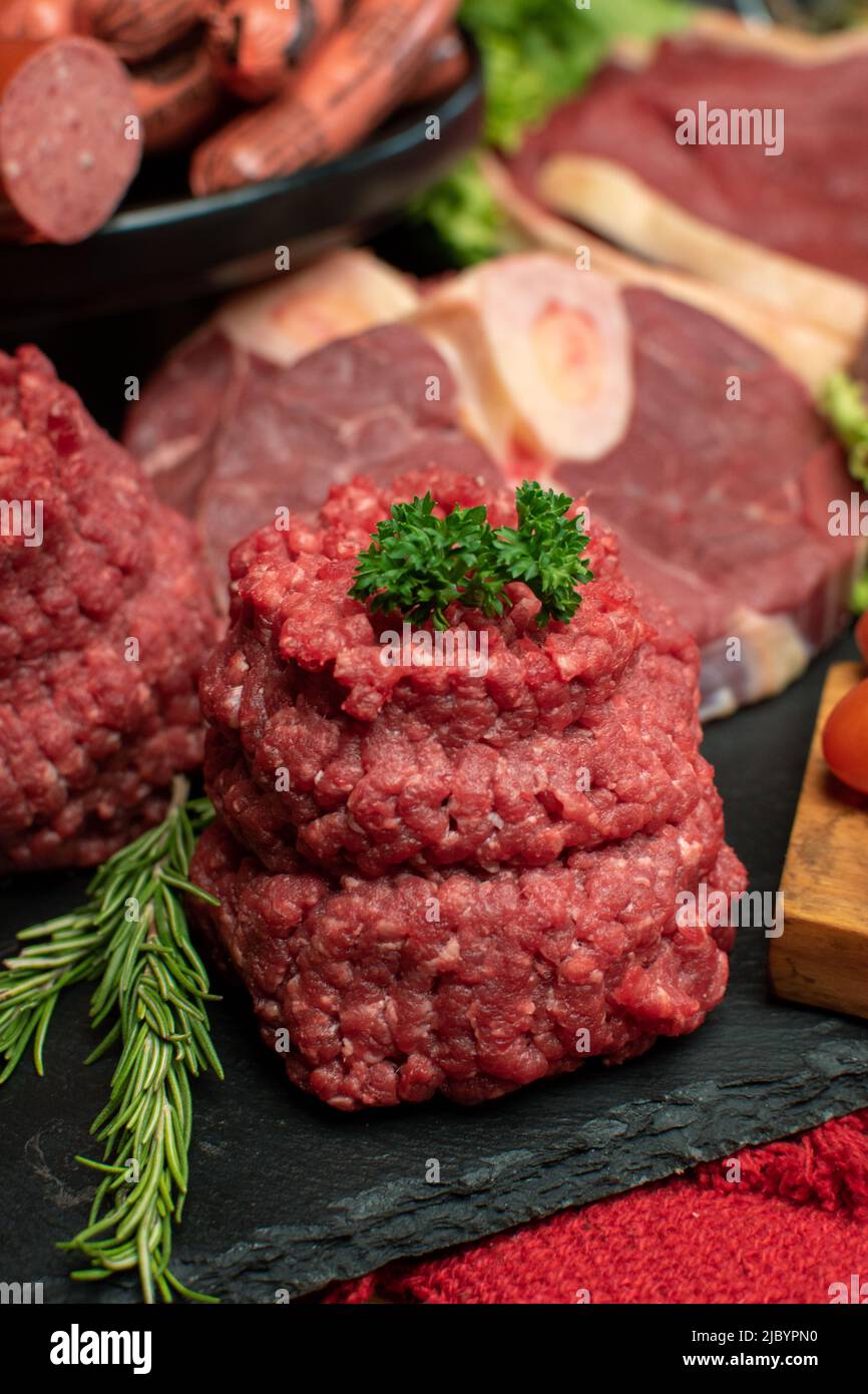 Fresh minced ground meat with parsley in a black board Stock Photo