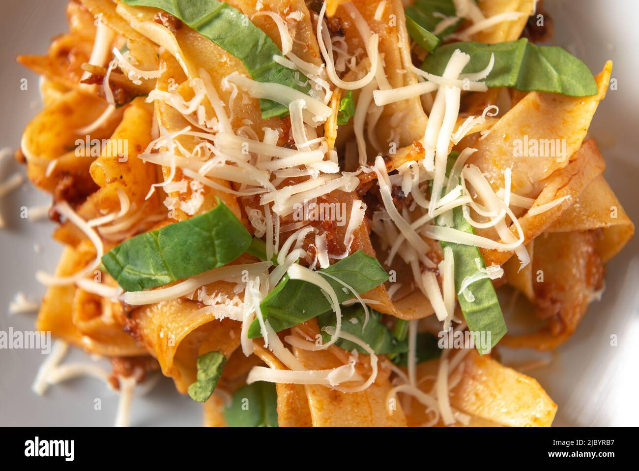 Pasta bolognese. Traditional tagliatelle with meat sauce italian dish of pasta with tomato and meat mince sauce served in a plate with parmesan cheese Stock Photo
