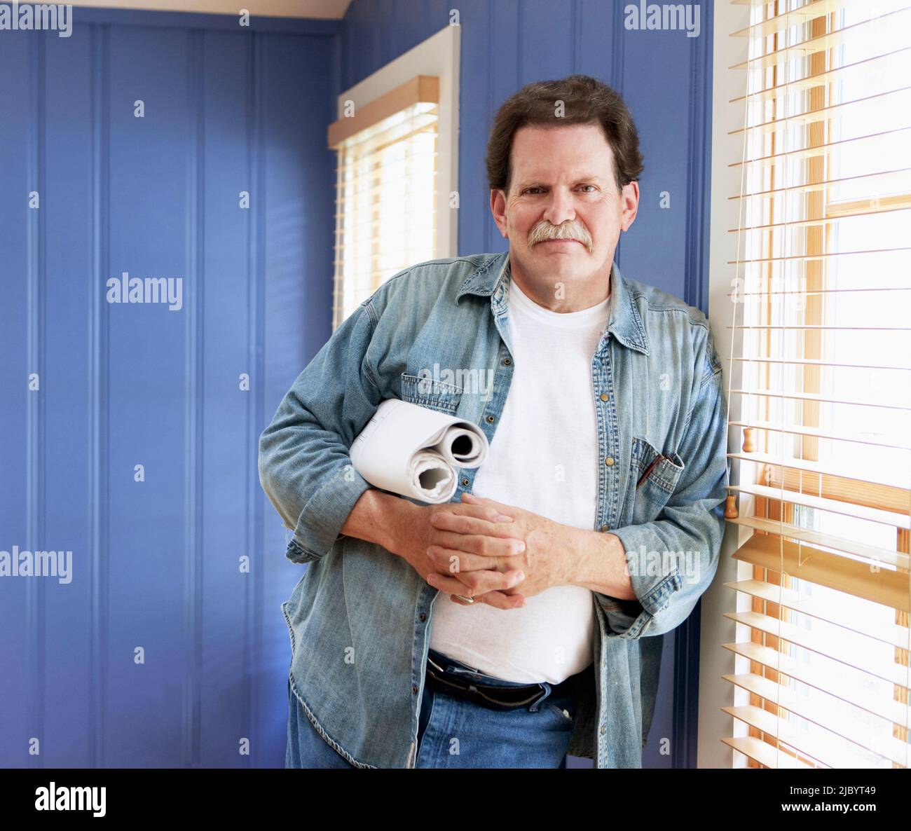 Architect holding blueprints Stock Photo