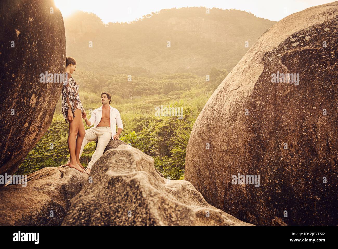 Hispanic couple on boulder Stock Photo
