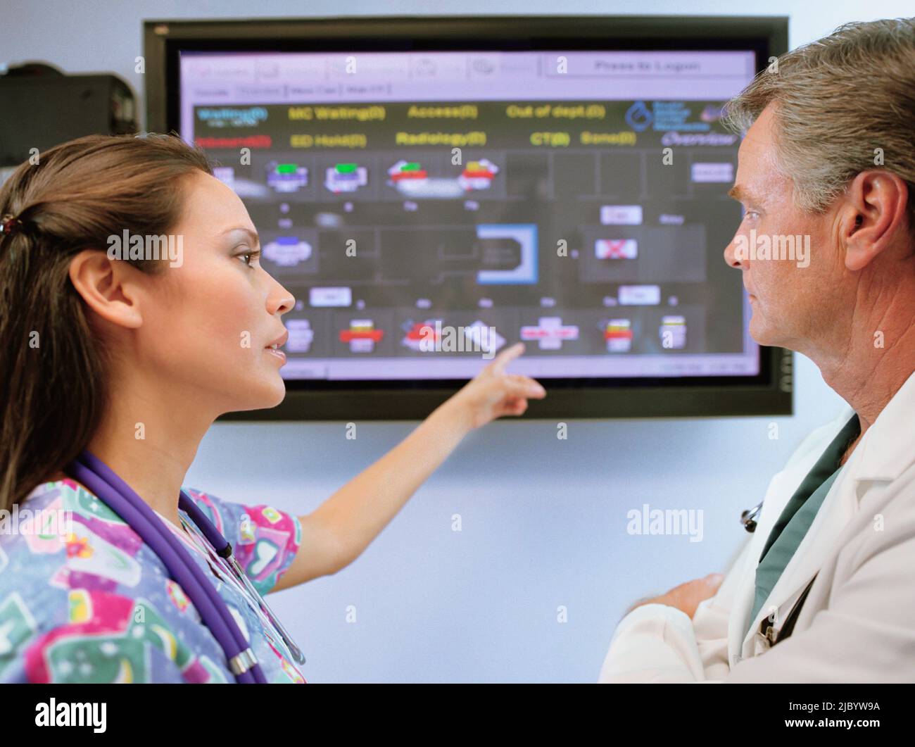 Multi-ethnic doctors looking at diagram Stock Photo