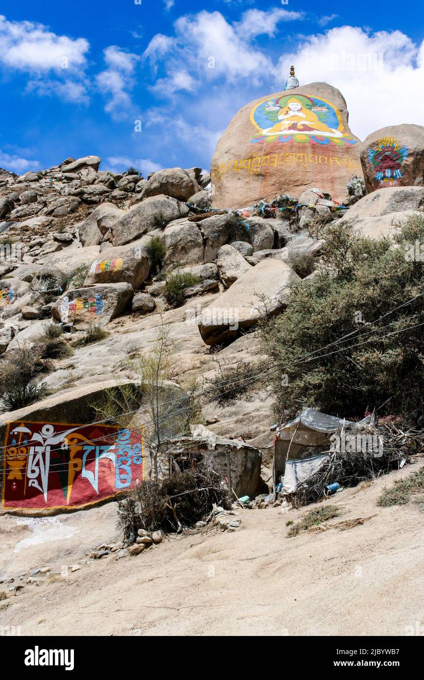 Tibetan Buddhist paintings on mani stones (om mani padme hum) in the Drepung Monastery of the at the foot of mount Gephel in Lhasa, Tibet. Stock Photo