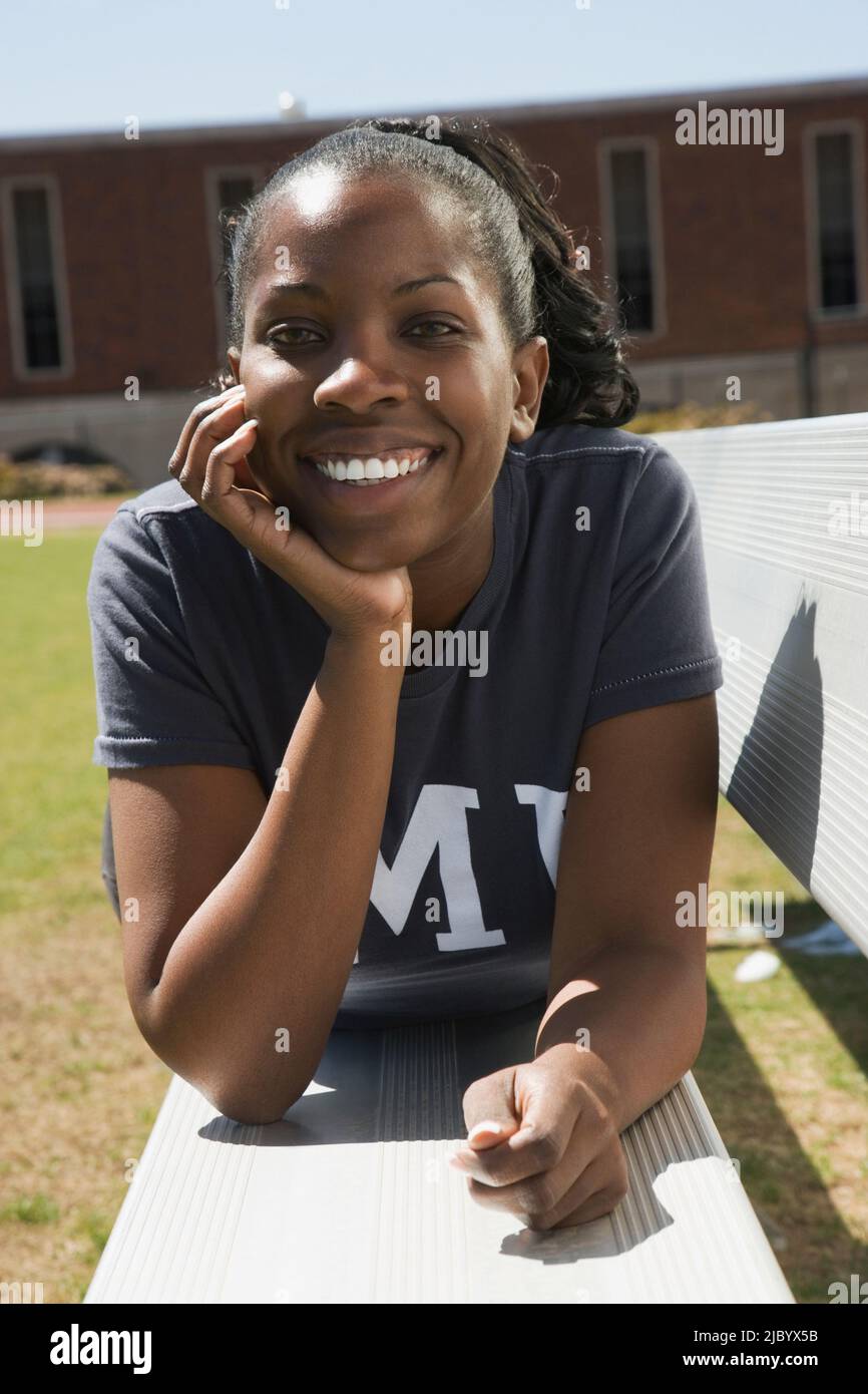 African American woman laying on bench Stock Photo