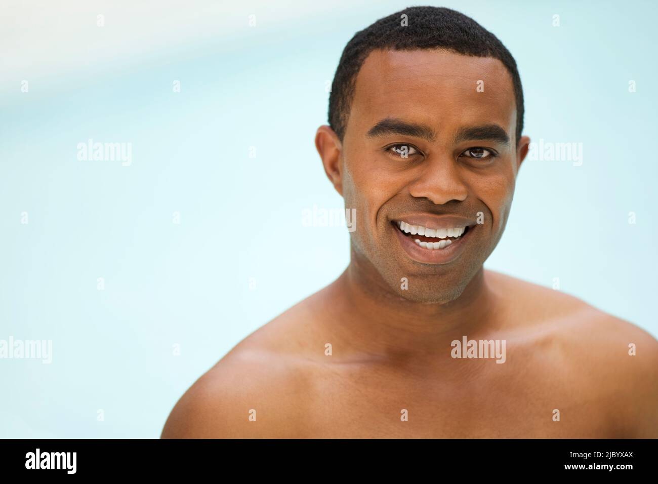 Smiling man near swimming pool Stock Photo