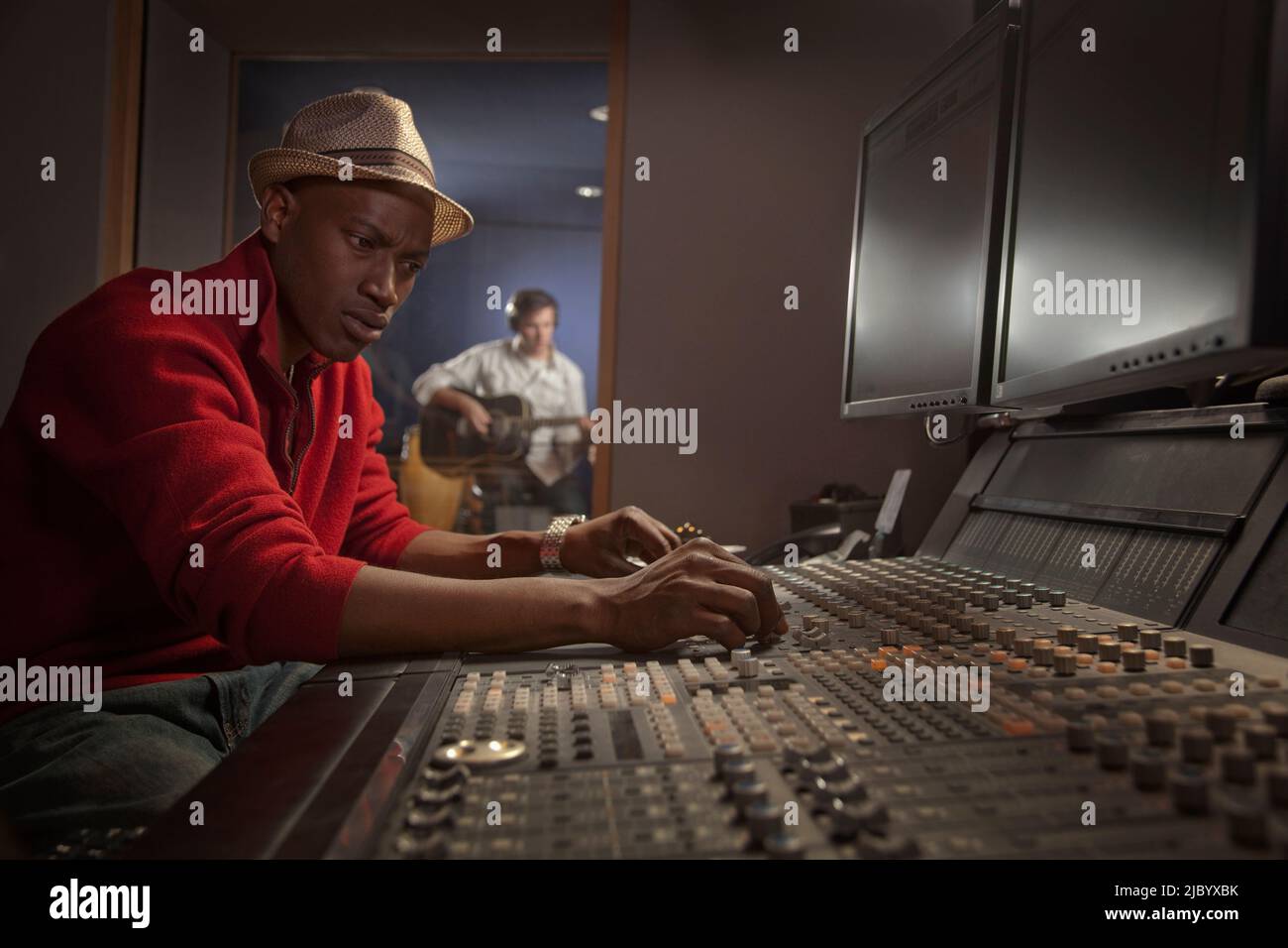 African American man working at audio control panel Stock Photo