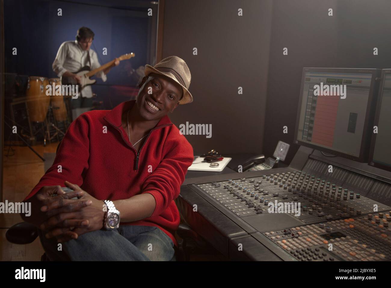 African American man working at audio control panel Stock Photo