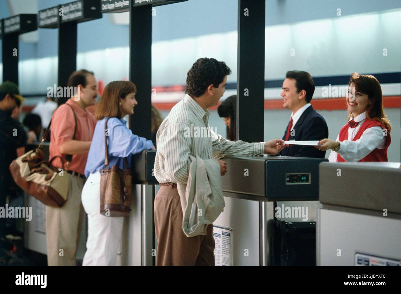 Customers at ticket counter in airport Stock Photo Alamy