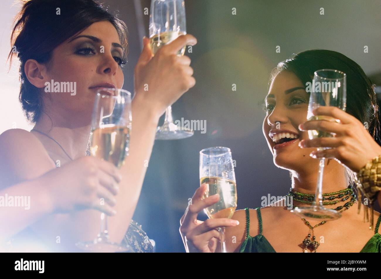 Multi-ethnic women drinking champagne Stock Photo