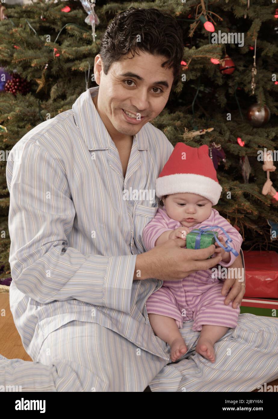 Hispanic father giving Christmas gift to baby Stock Photo Alamy