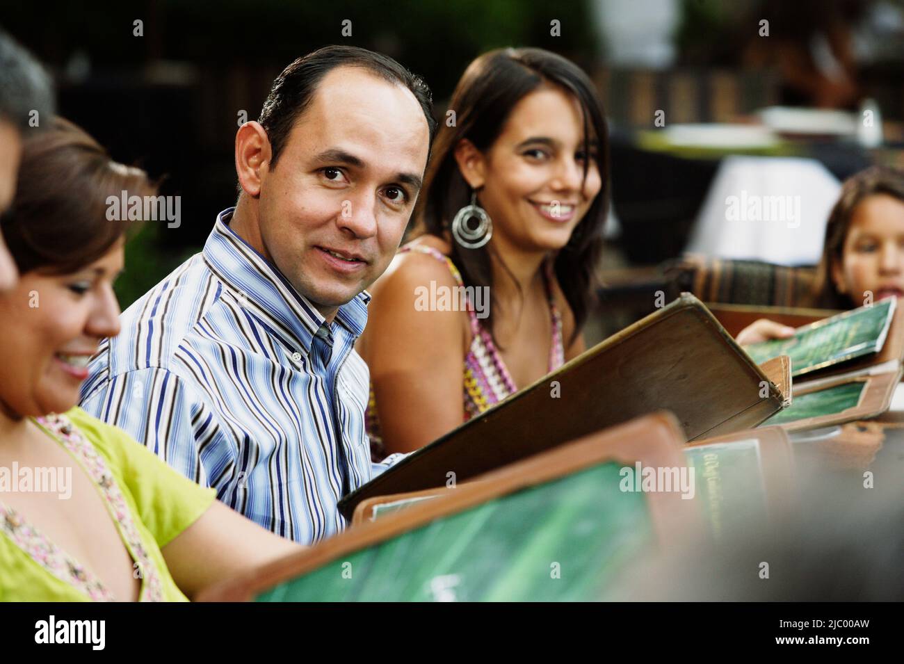 Middle-aged man smiling for the camera at a restaurant Stock Photo