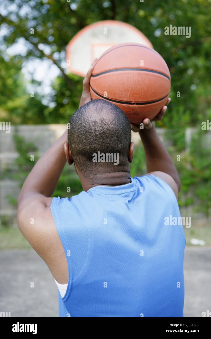 Man shooting basketball Stock Photo - Alamy