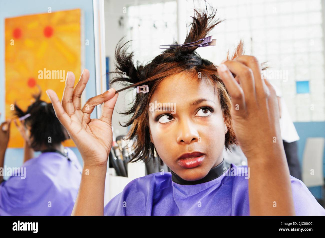 Young woman examining herself in the mirror Stock Photo