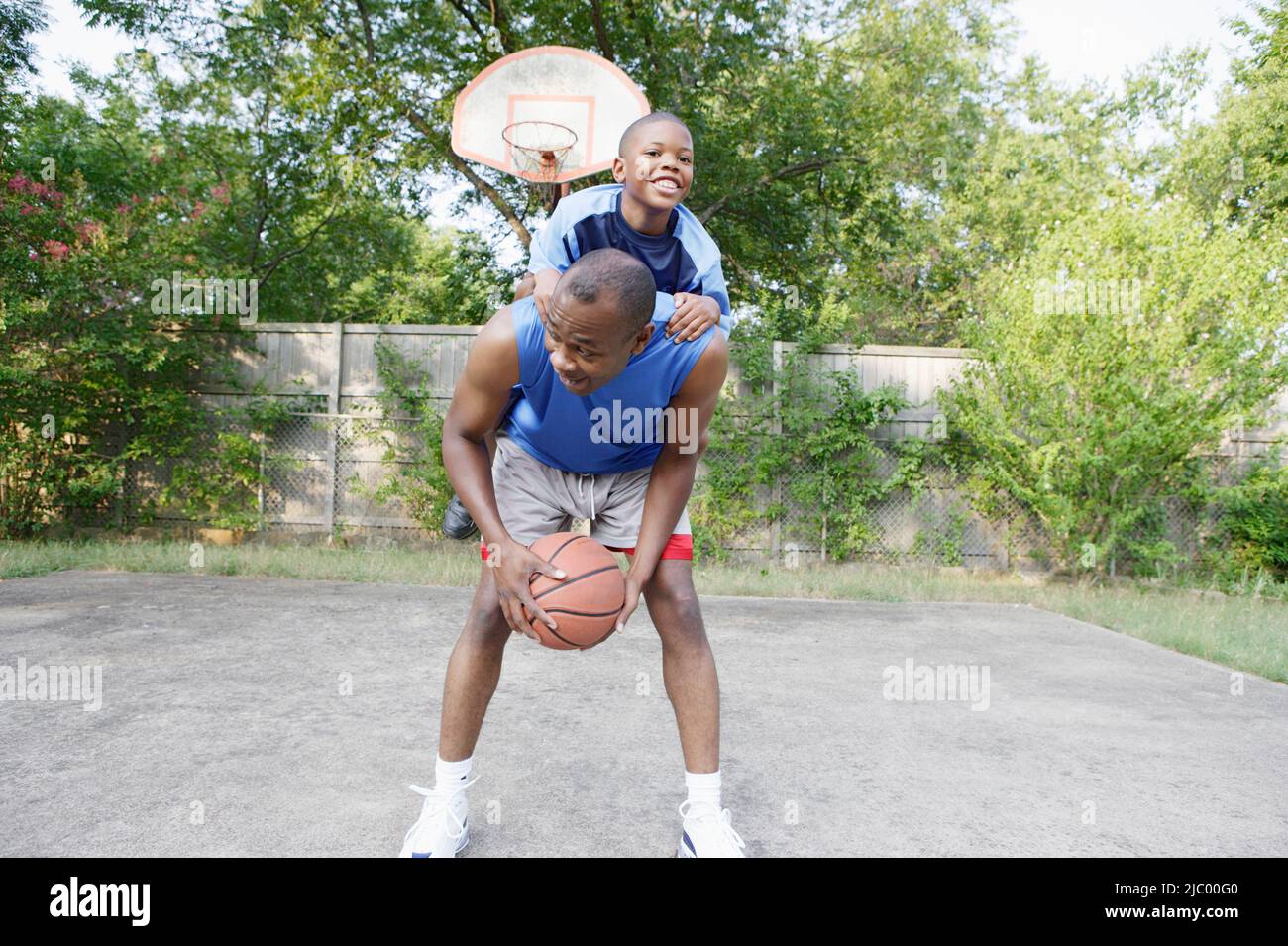 Father and son playing basketball Stock Photo