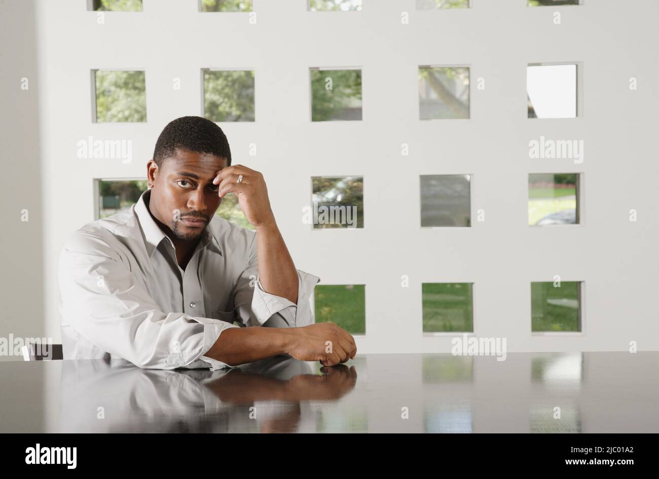 African american man sitting table hi-res stock photography and images ...