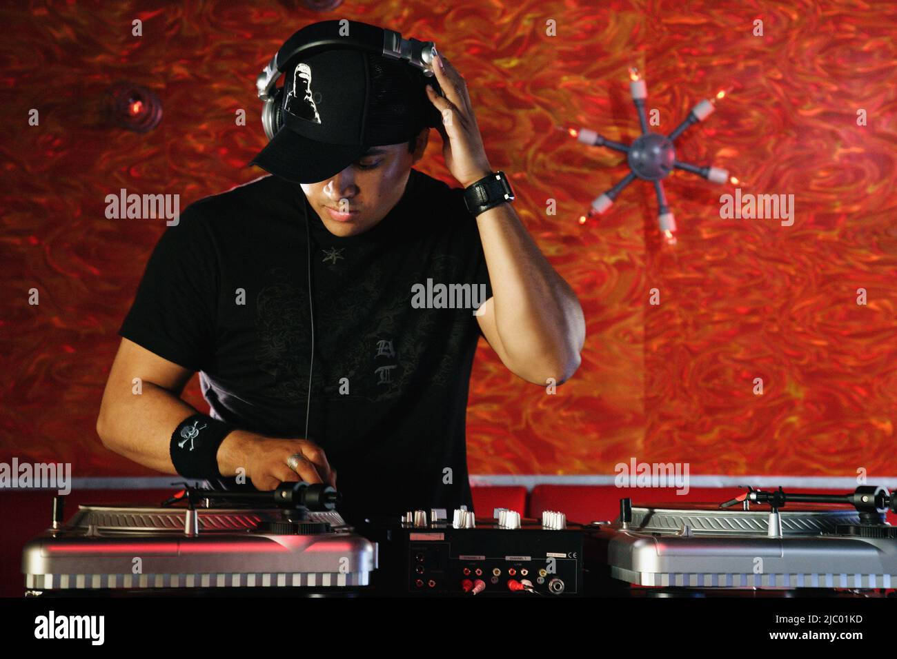 Hispanic male DJ spinning records Stock Photo