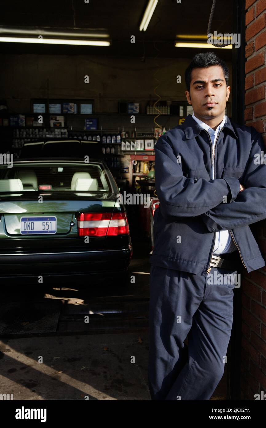 Young man posing for the camera in garage Stock Photo