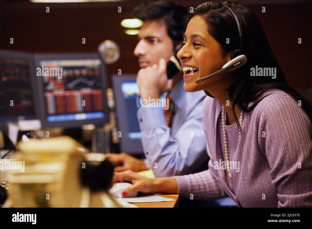 Businesswoman laughing while talking on a headset Stock Photo