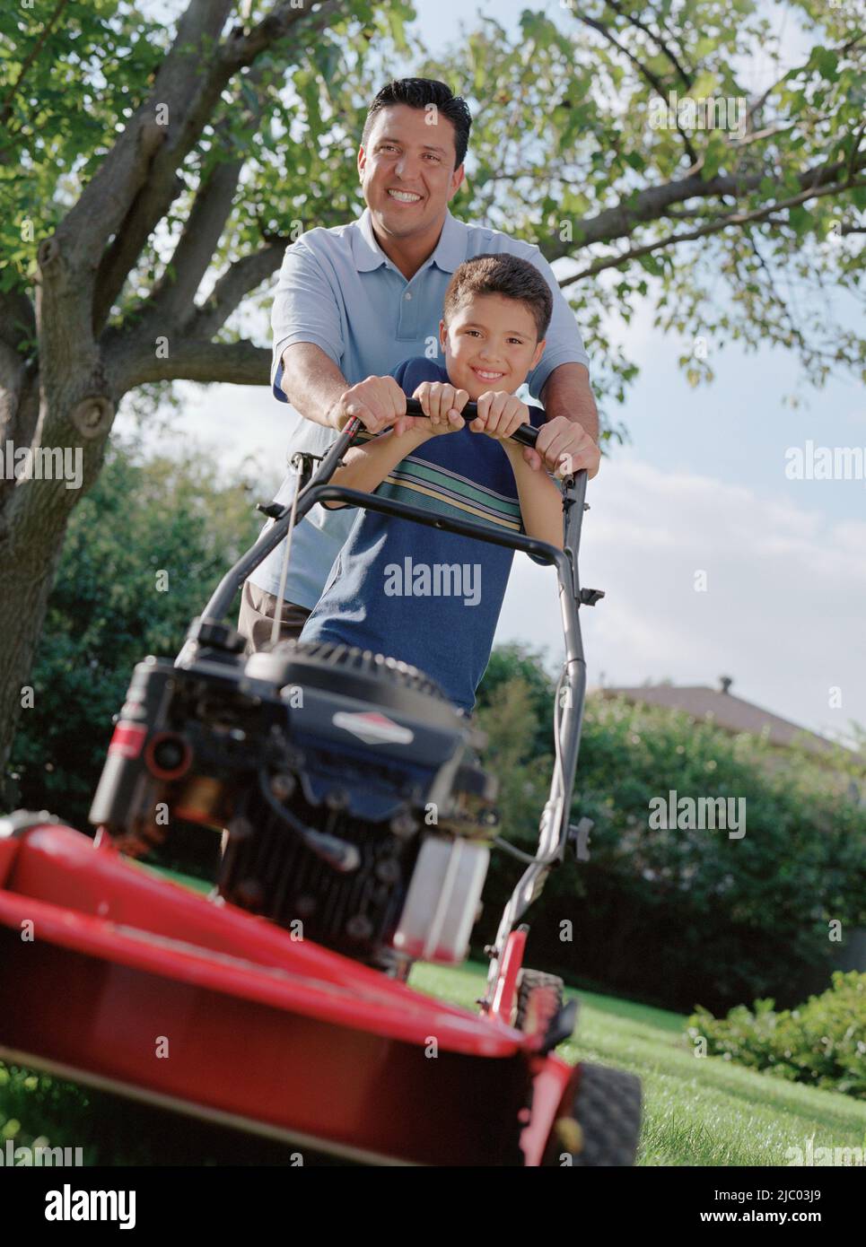 Father and son mowing the lawn together Stock Photo - Alamy
