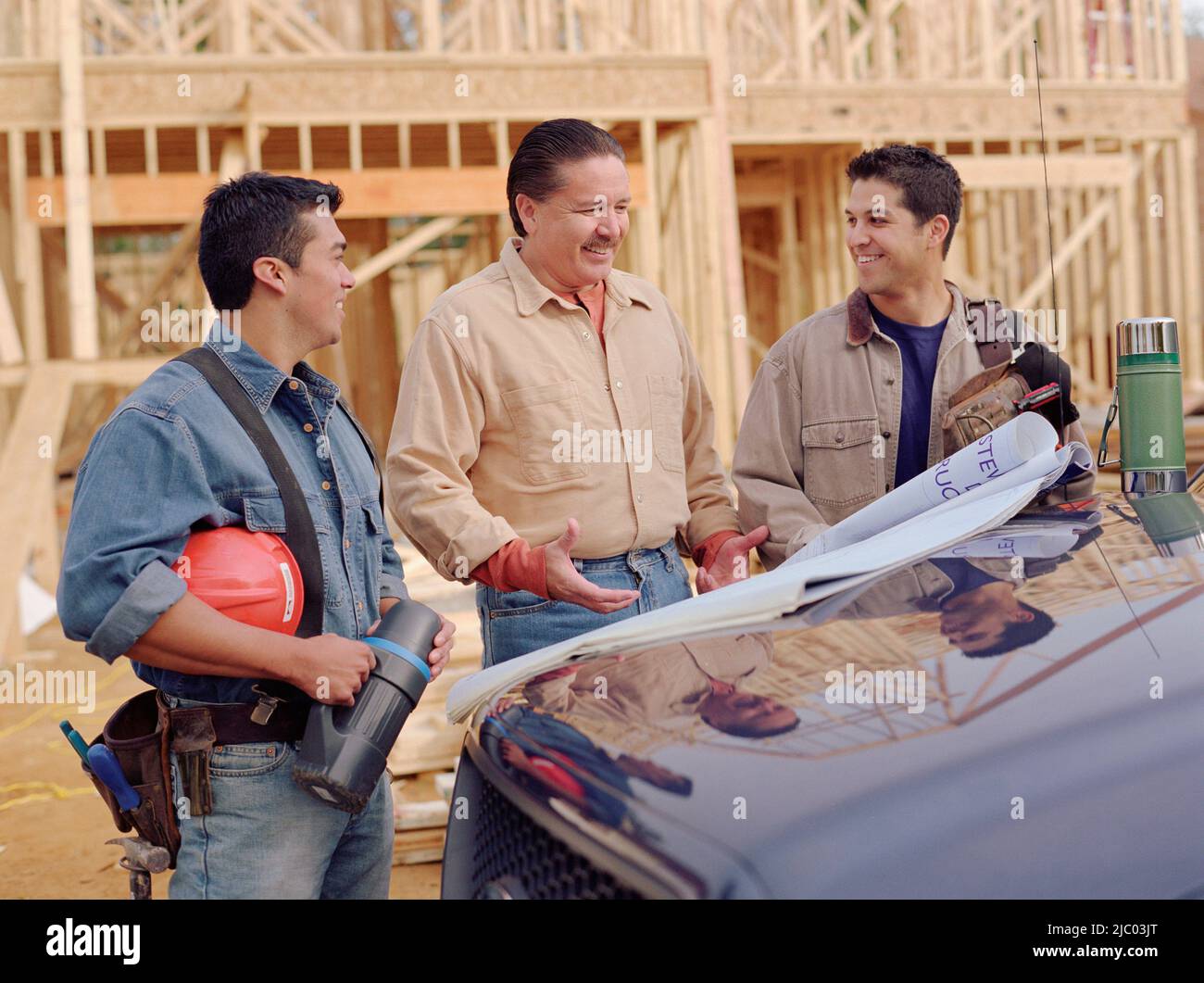 manual-workers-examining-blueprints-stock-photo-alamy